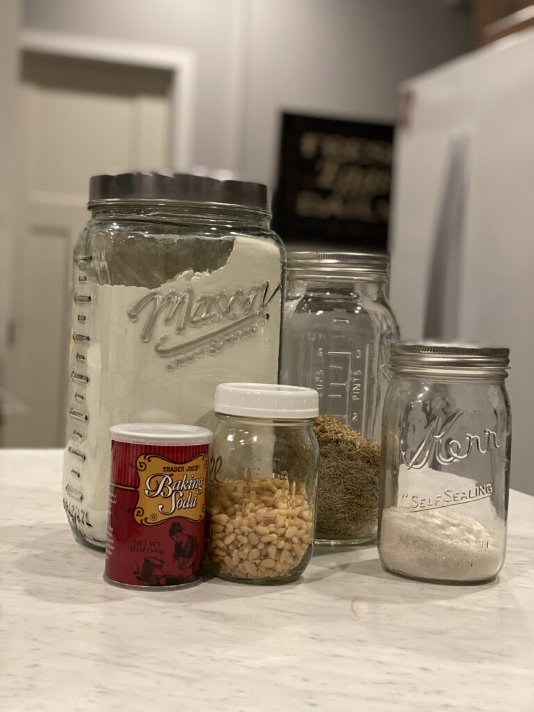 spices in mason jars sitting on a white counter