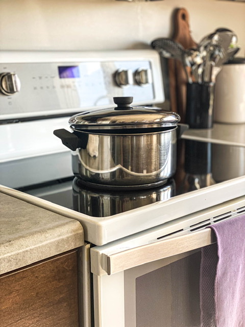 stock pot with a vented lid sitting on a stove