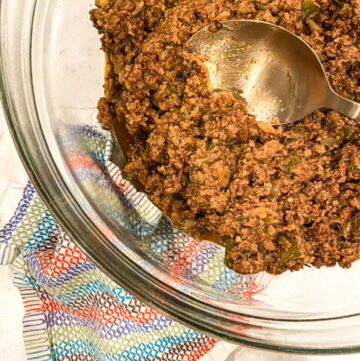 glass bowl with a gold spoon in hidden veggie beef taco meat