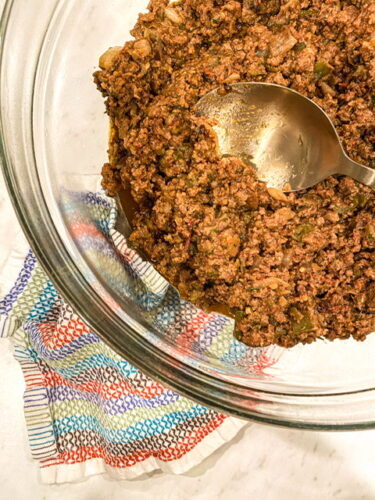 glass bowl with a gold spoon in hidden veggie beef taco meat