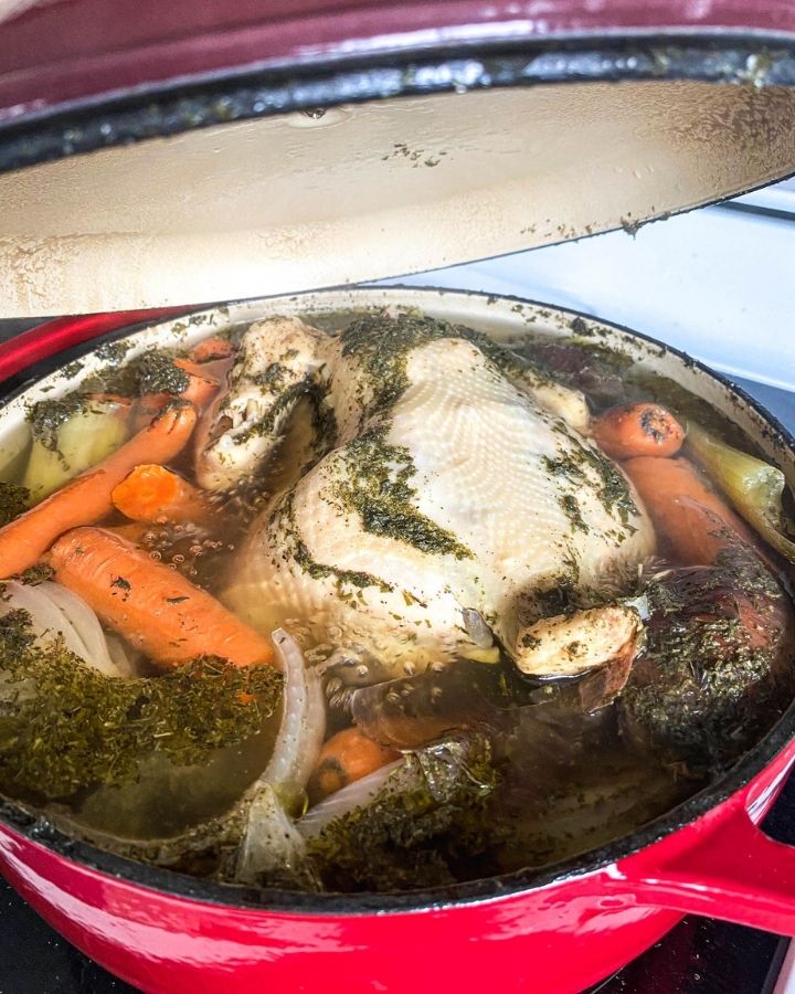 dutch oven on the stove with nourishing bone broth inside