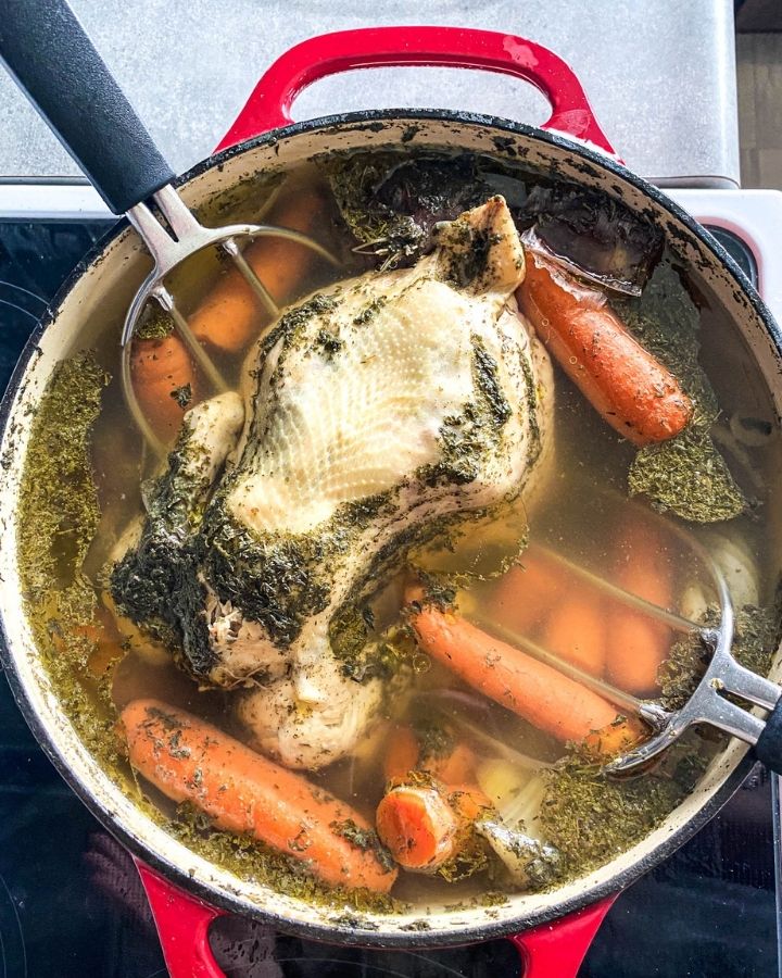 nourishing bone broth in a dutch oven on the stove