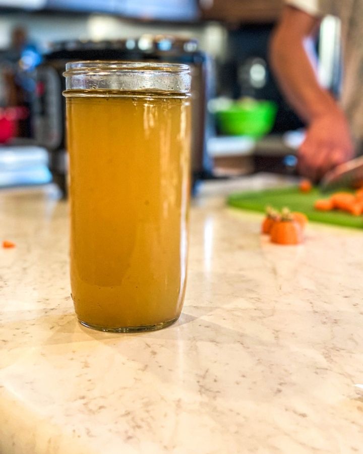 jar of nourishing bone broth sitting on a white counter