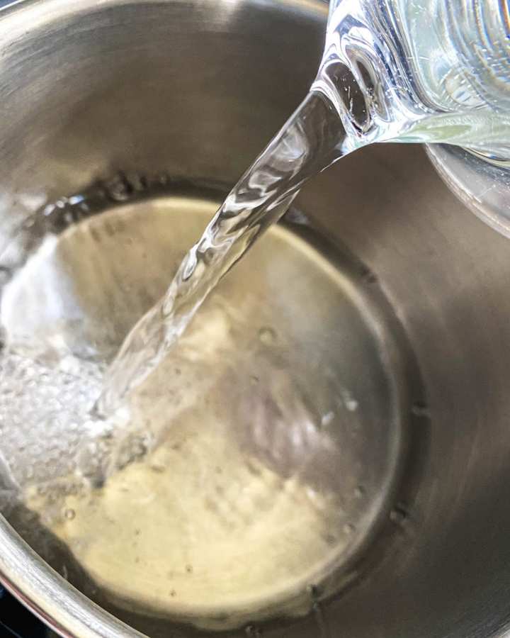 water pouring into saucepan