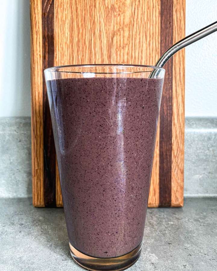 berry and beet greens smoothie in a glass