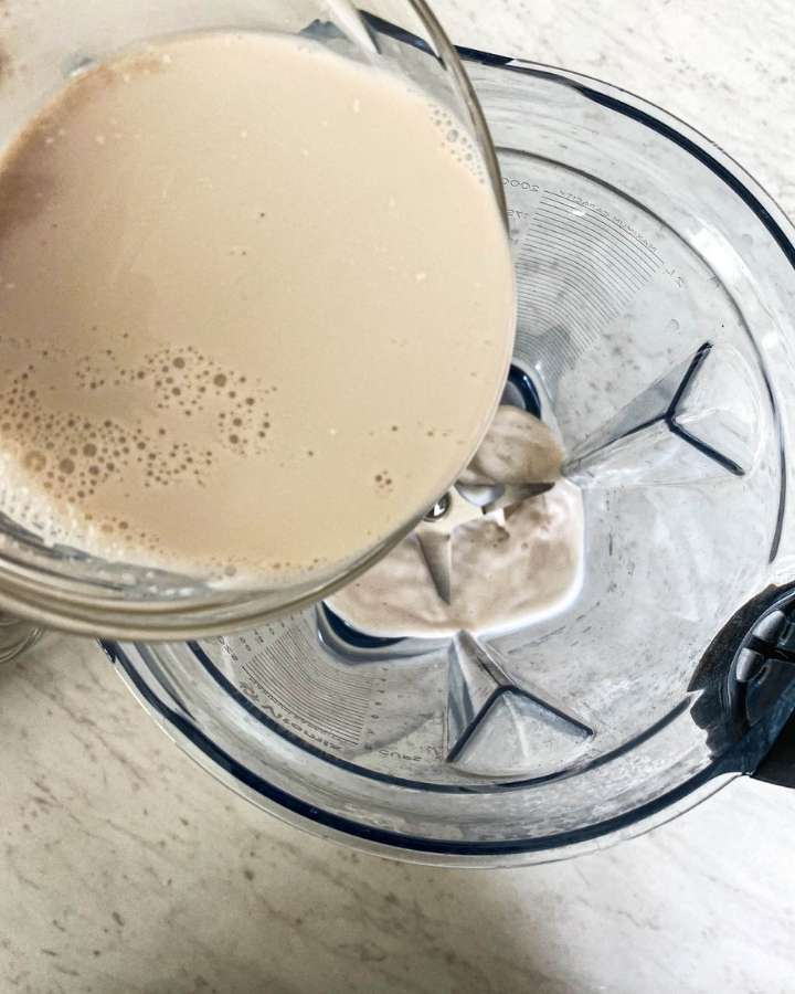 almond milk pouring into a blender