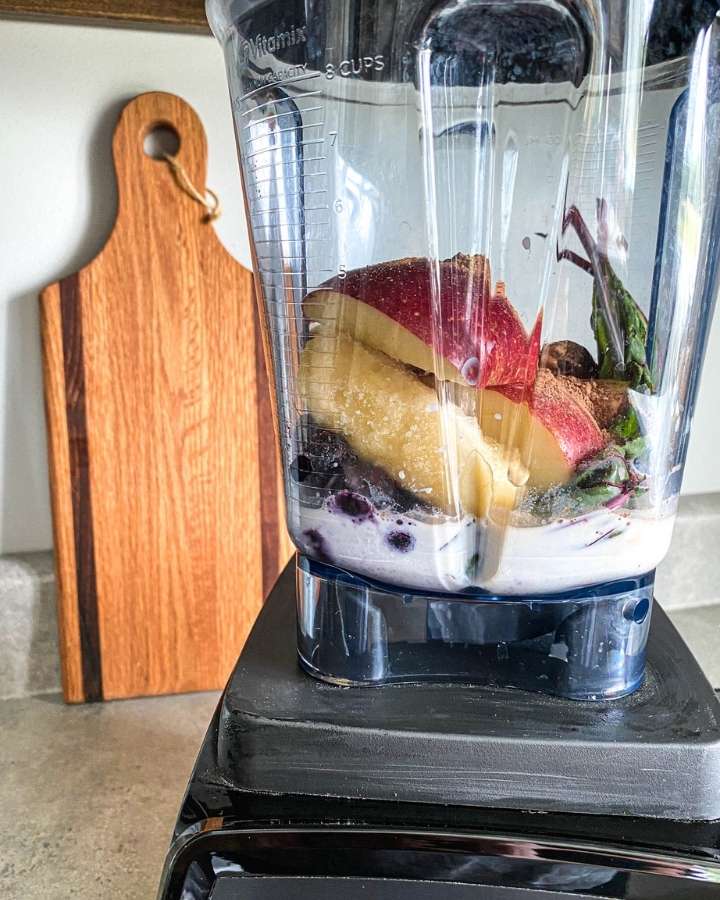 ingredients in a blender for berry and beet green smoothie