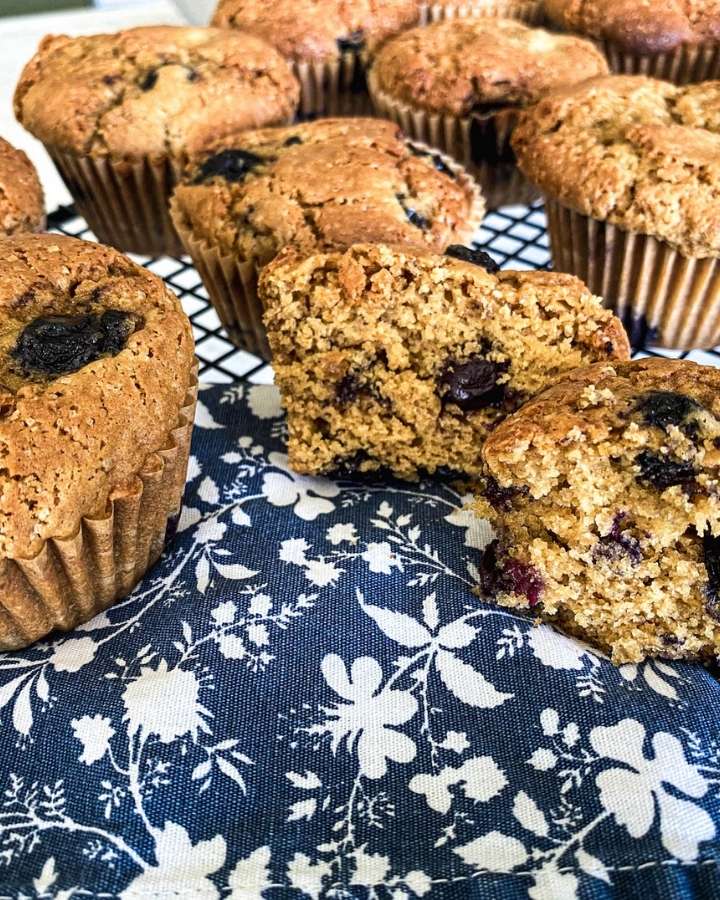 sourdough blueberry muffins on a wire rack