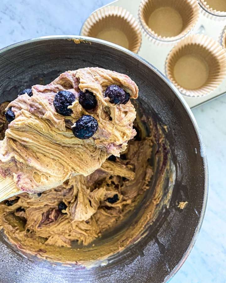 sourdough blueberry muffin batter on a wooden spoon