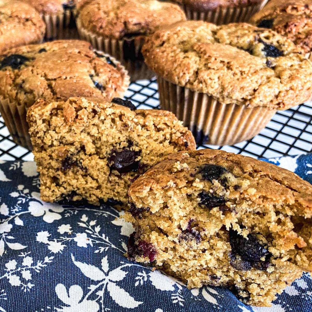 blueberry muffins on a blue and white flower cloth