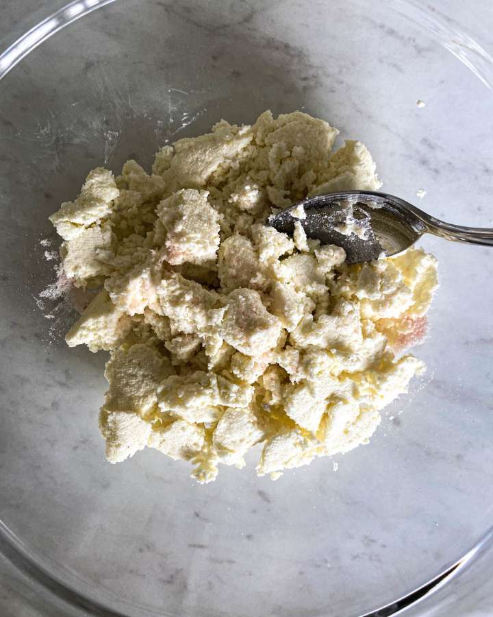 ricotta cheese being mixed with salt