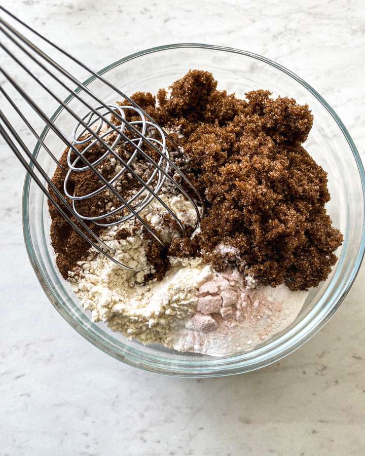 bowl of ingredients on a white counter with a thick in them