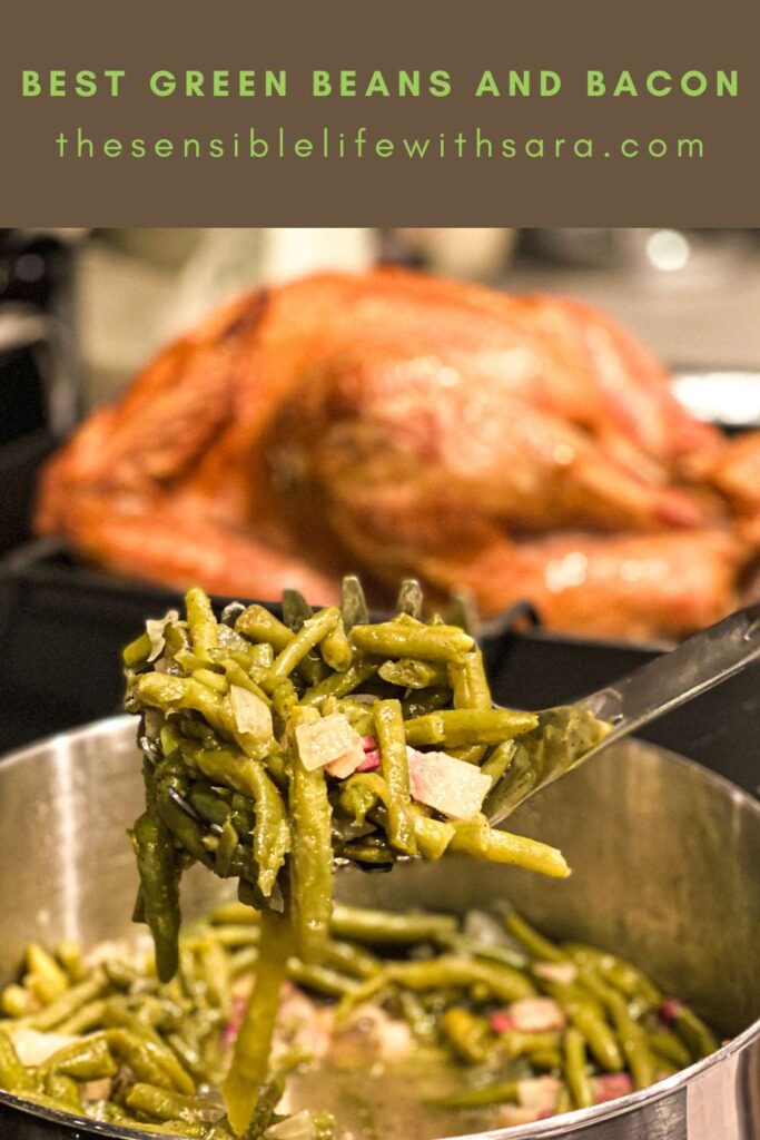 cooked best green beans and bacon held on a serving spoon in front of turkey