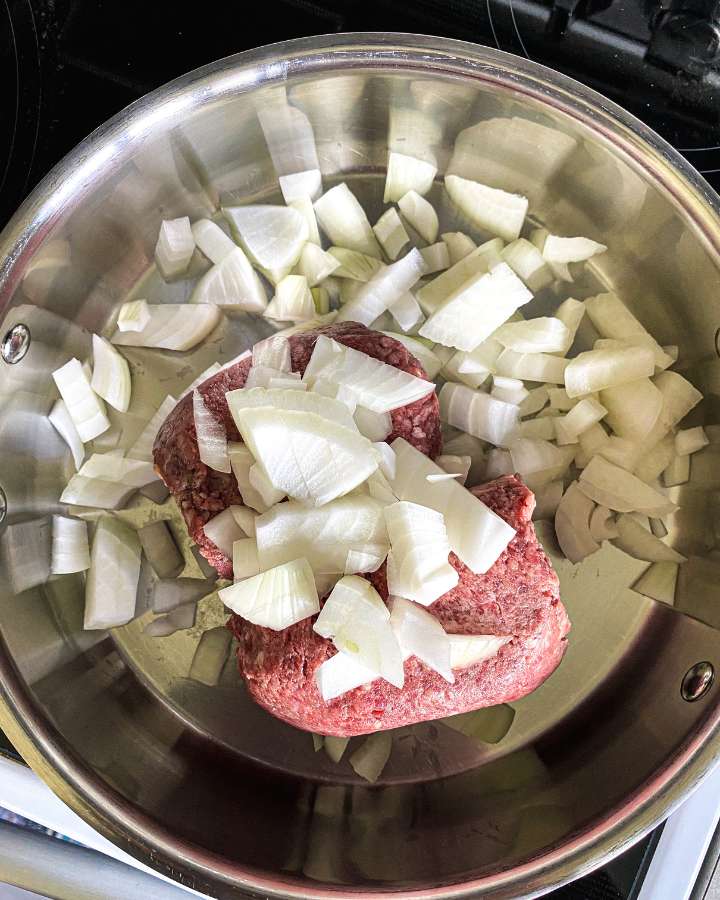 ground beef and onions in a stainless skillet